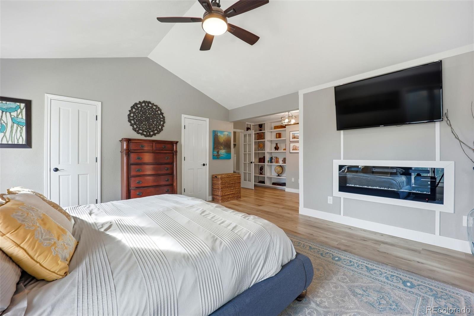 5000 South Perry Park Road Sedalia, CO 80135 - Photo 18 of 50 a spacious bedroom with a bed and a flat screen tv