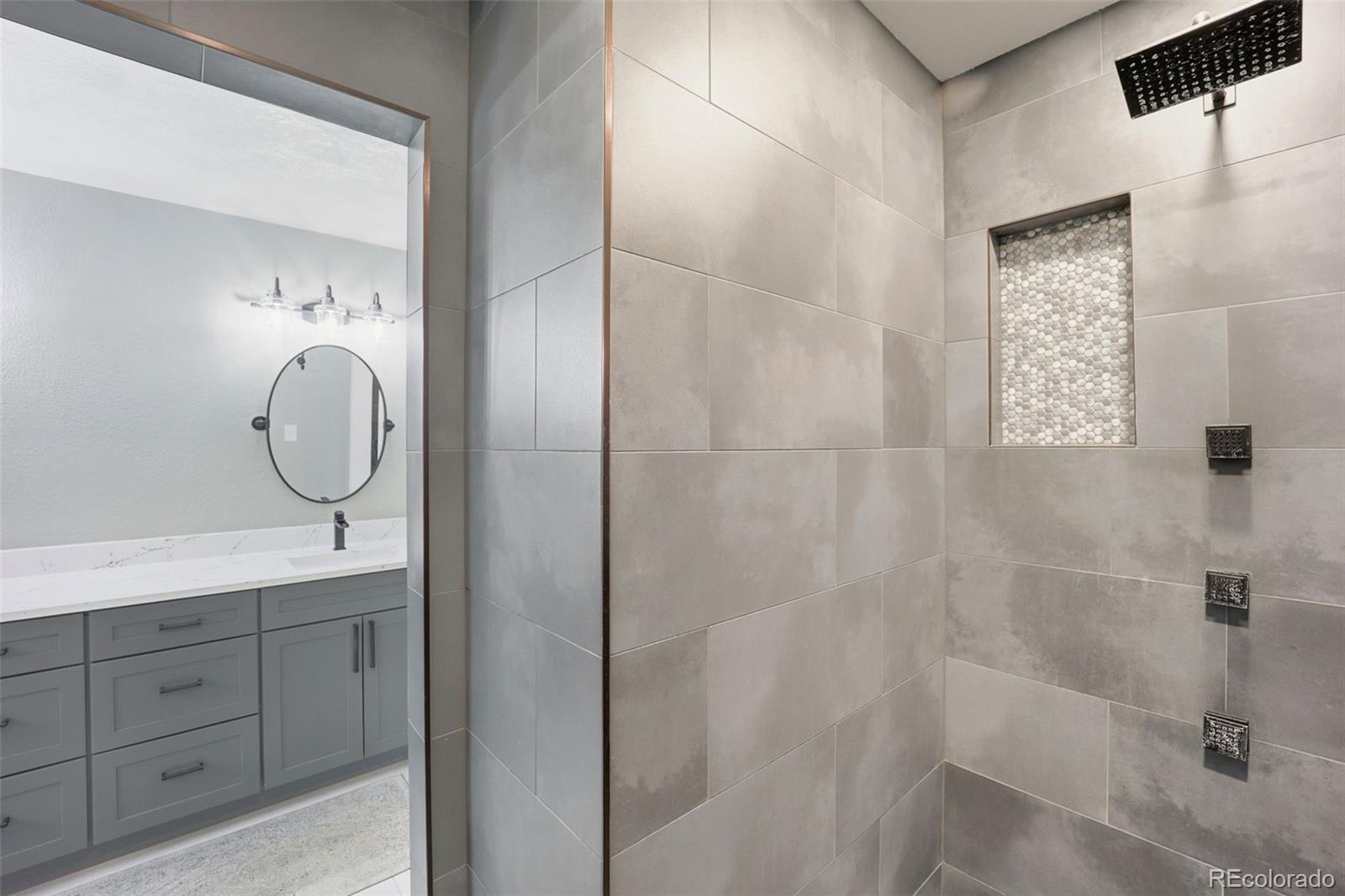5000 South Perry Park Road Sedalia, CO 80135 - Photo 20 of 50 a bathroom with a mirror and shower