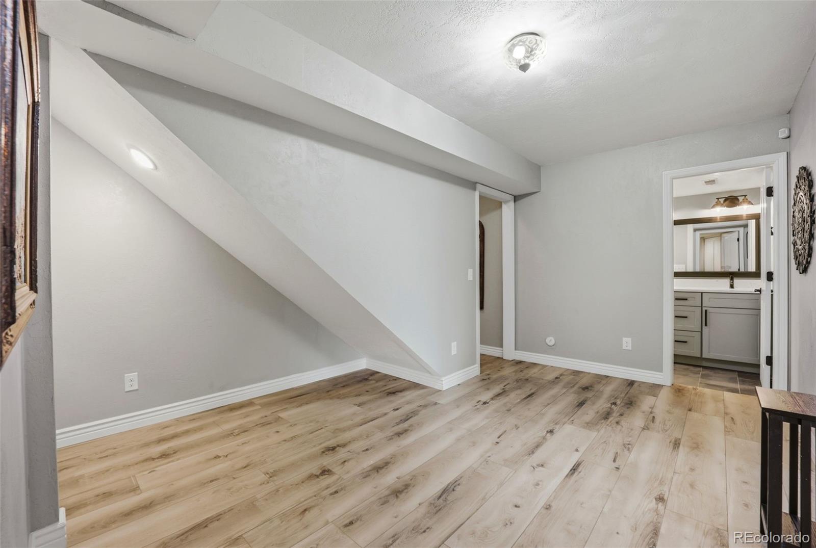 5000 South Perry Park Road Sedalia, CO 80135 - Photo 24 of 50 a view of empty room with wooden floor