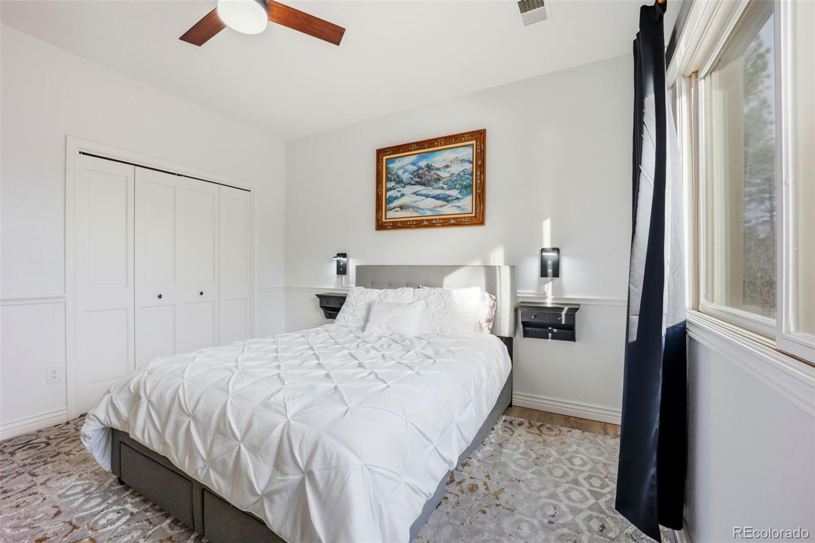 5000 South Perry Park Road Sedalia, CO 80135 - Photo 26 of 50 a bedroom with a bed and a large mirror