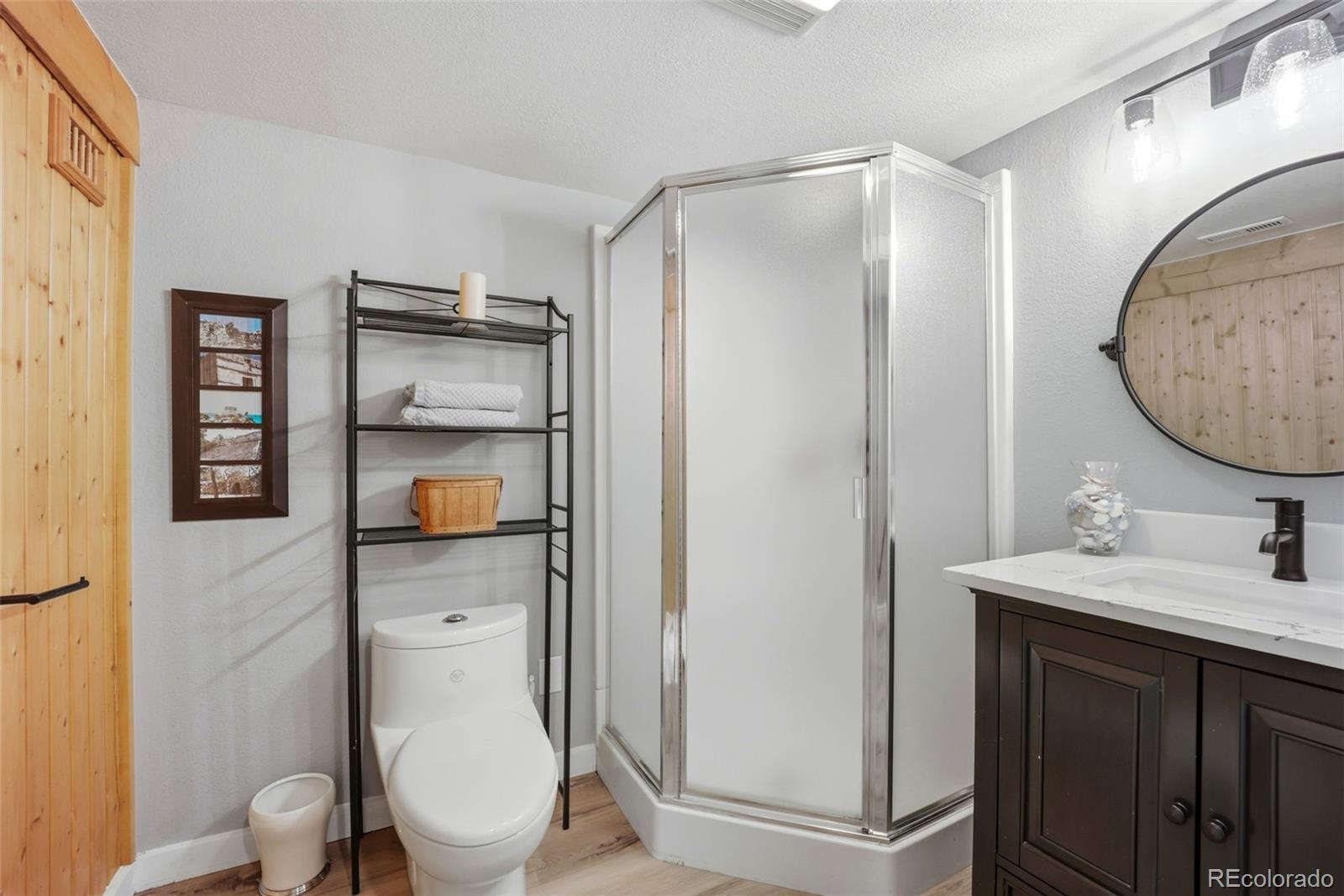 5000 South Perry Park Road Sedalia, CO 80135 - Photo 29 of 50 a bathroom with a toilet sink and mirror