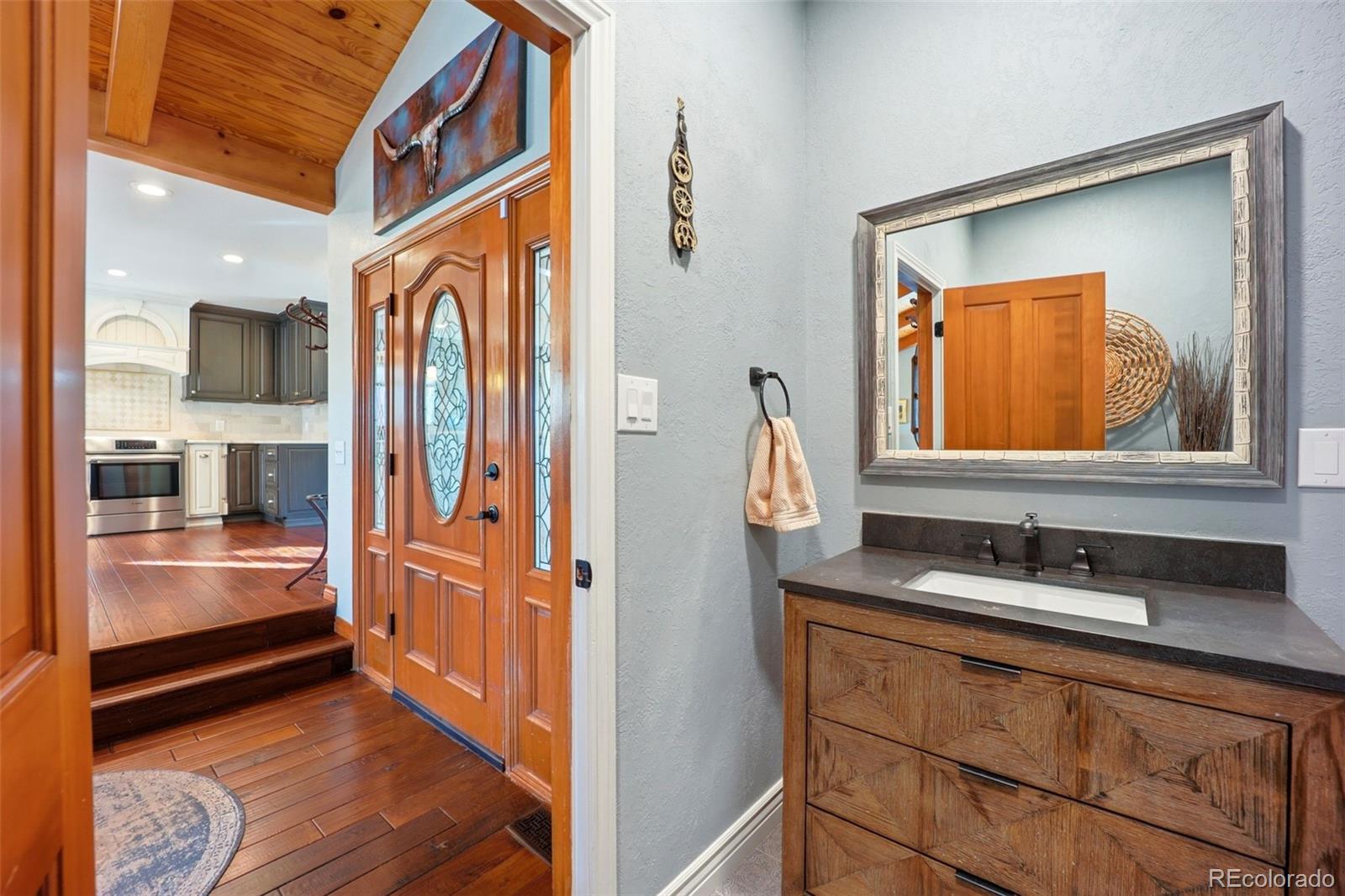 5000 South Perry Park Road Sedalia, CO 80135 - Photo 9 of 50 a bathroom with a sink and a mirror