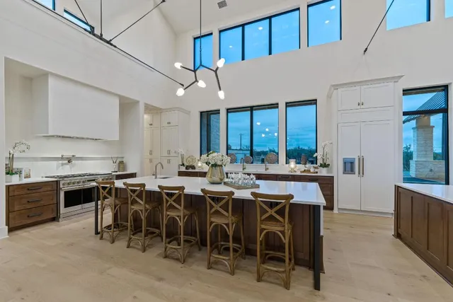 a spacious bedroom with a bed a couch and a large window