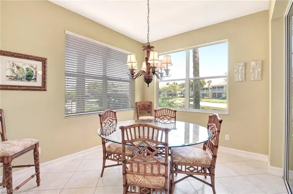 a view of a dining room with furniture wooden floor and a chandelier