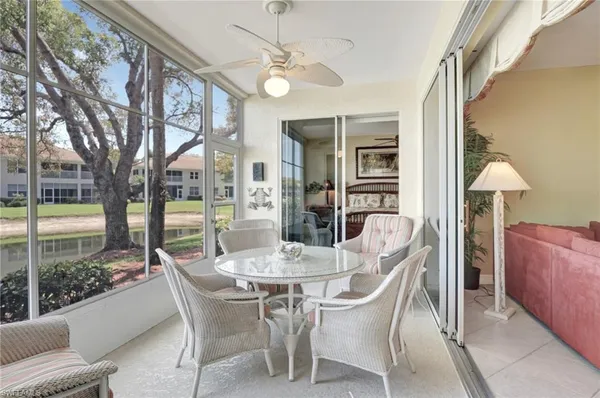 a dining room with furniture a chandelier and window
