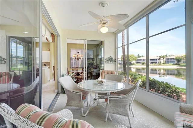 a dining room with furniture a chandelier and glass door