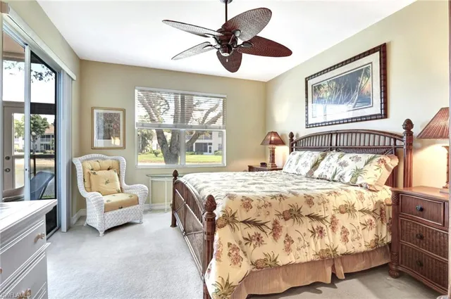 a bedroom with a bed couches and a large window