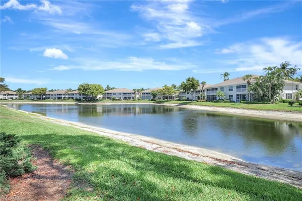a view of a lake with houses in the back