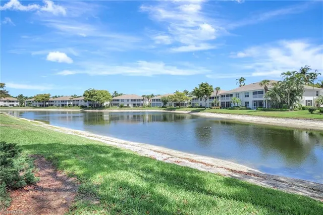 a view of a lake with houses in the back
