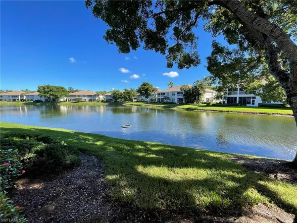 a view of a lake with houses in the back