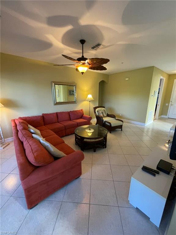 784 Carrick Bend Circle, Unit 101 Naples, FL 34110 - Photo 5 of 34 a living room with furniture and a chandelier