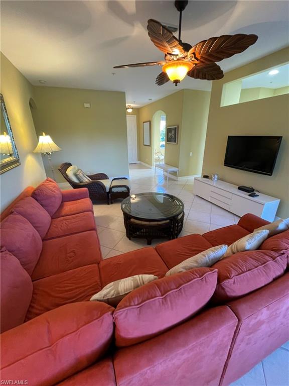 784 Carrick Bend Circle, Unit 101 Naples, FL 34110 - Photo 7 of 34 a projector room with furniture and a flat screen tv