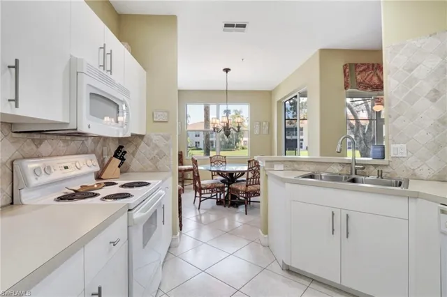 a kitchen with cabinets a sink and appliances