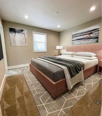 a bedroom with a large bed and a window