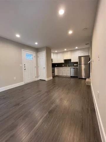 a view of kitchen with cabinets and wooden floor