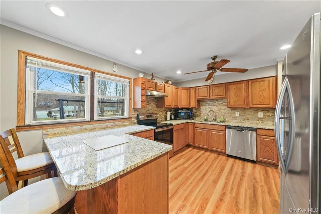 24 Marc Terrace Monroe, NY 10950 - Photo 2 of 28 a large kitchen with kitchen island a large window and cabinets