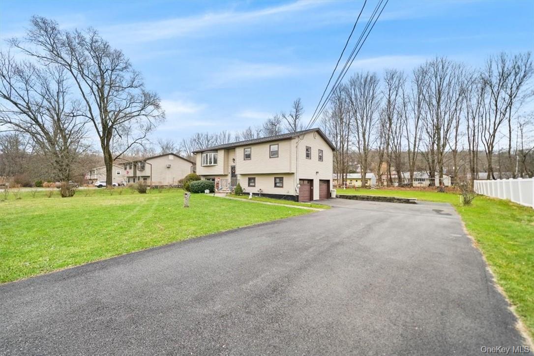 24 Marc Terrace Monroe, NY 10950 - Photo 21 of 28 a view of a house with a big yard and palm trees