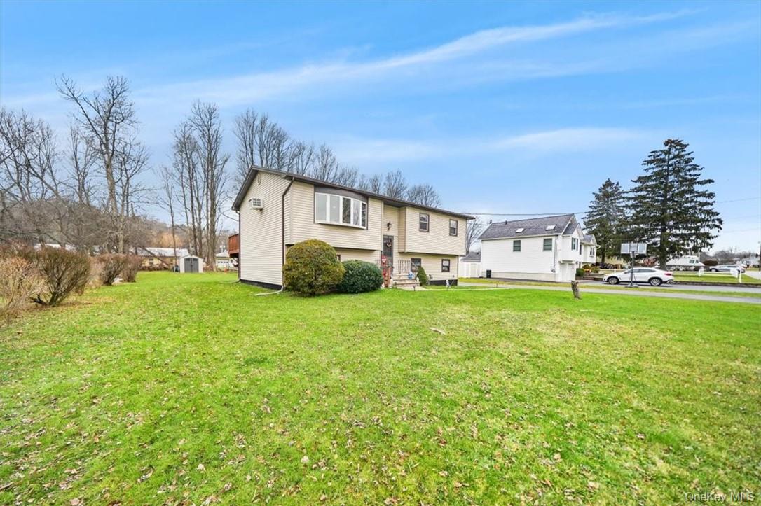 24 Marc Terrace Monroe, NY 10950 - Photo 22 of 28 a view of a white house with a big yard and large trees