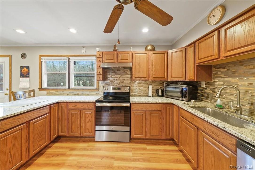24 Marc Terrace Monroe, NY 10950 - Photo 5 of 28 a kitchen with stainless steel appliances granite countertop a stove and a sink