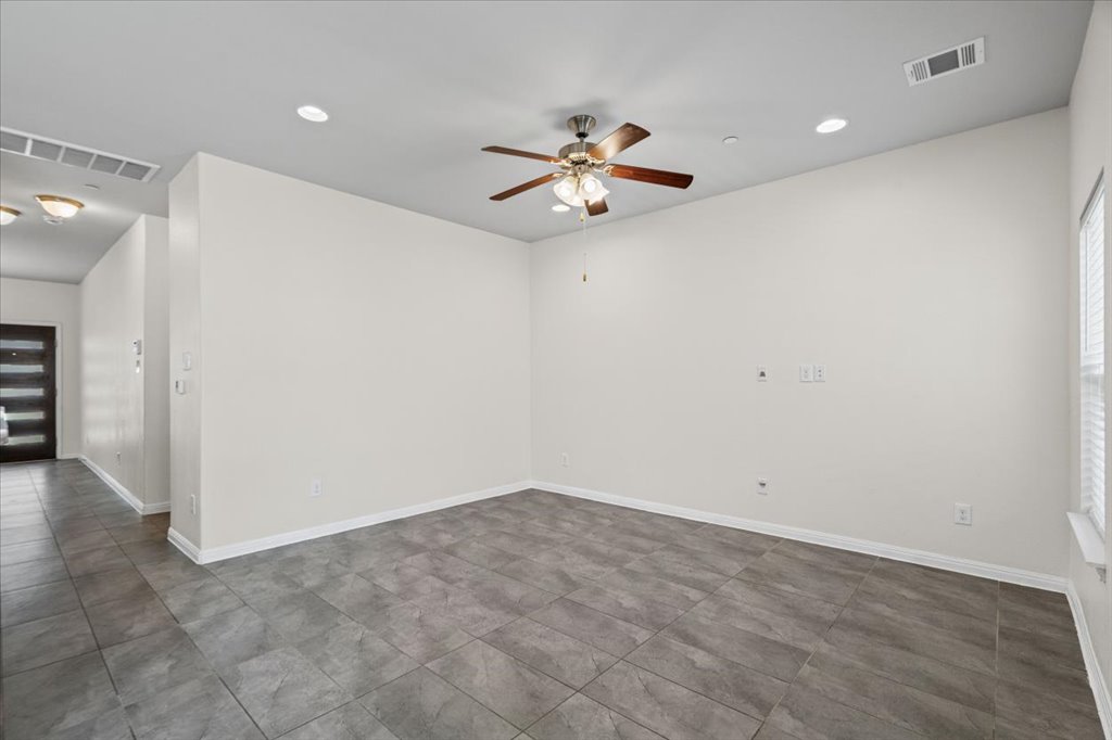 1502 Airedale Road, Unit 2502 Austin, TX 78748 - Photo 10 of 28 A spacious living area features elegant tile flooring, recessed lighting, and a prominent ceiling fan.
