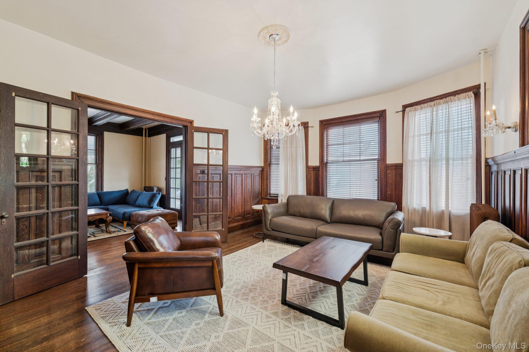 397 Split Rock Road Syosset, NY 11791 - Photo 7 of 29 a living room with furniture and a chandelier