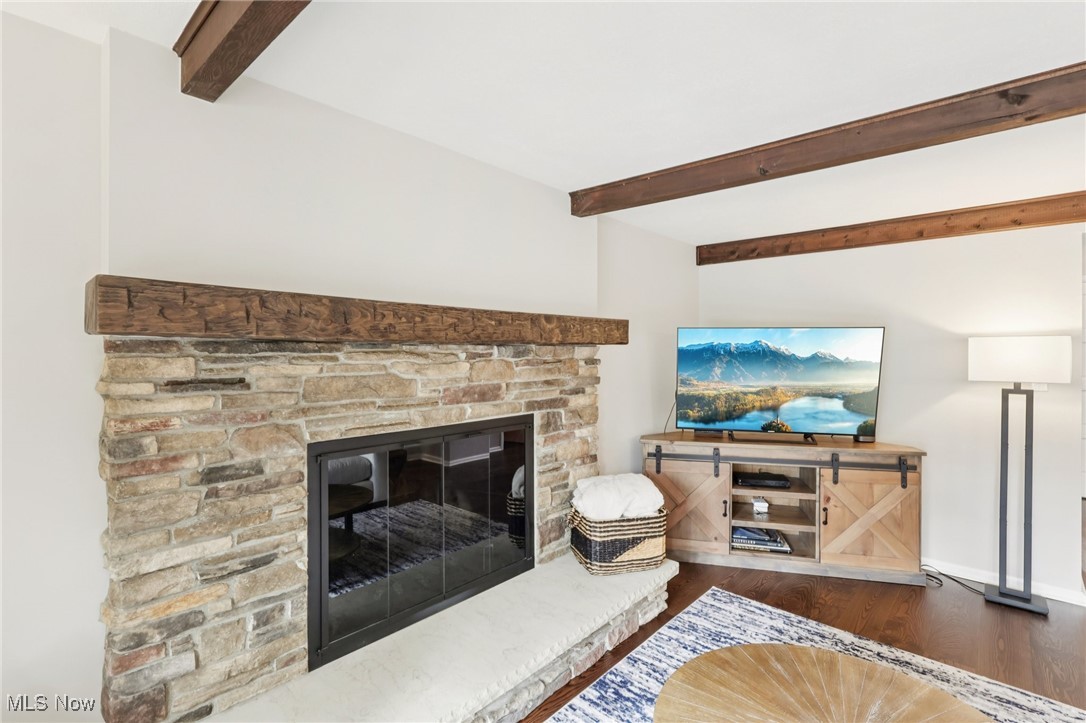 934 Canyon View Road Northfield, OH 44067 - Photo 5 of 24 Living room with beam ceiling, dark wood-style floors, and a fireplace