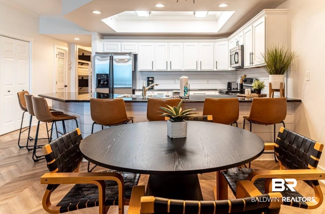 27800 Canal Road, Unit 212 Orange Beach, AL 36561 - Photo 15 of 43 Kitchen with stainless steel appliances, recessed lighting, dark countertops, and a raised ceiling