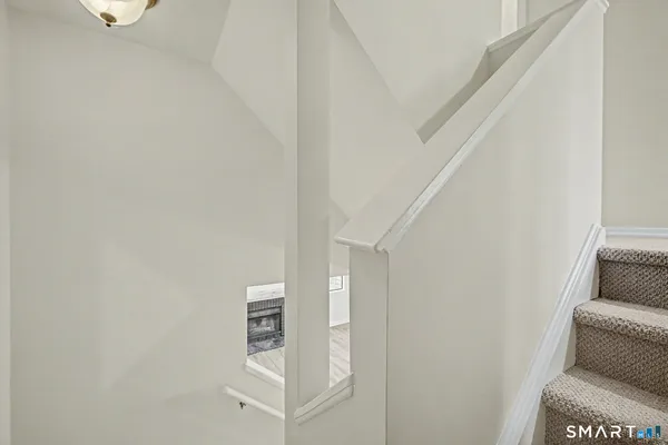 a living room with furniture and a white wall