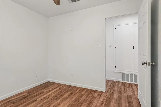 a view of a room with wooden floor
