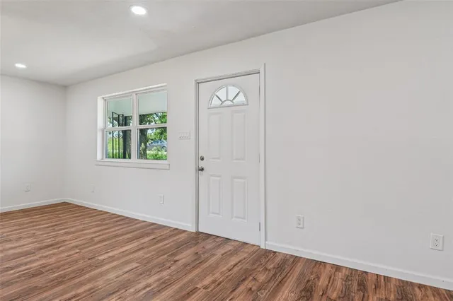 an empty room with windows and closet