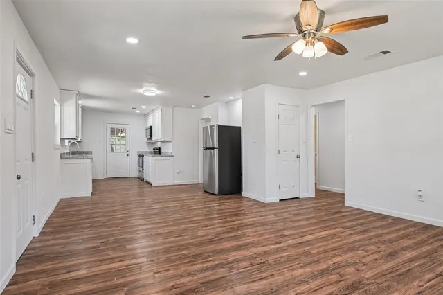 a view of a kitchen with a refrigerator and a ceiling fan