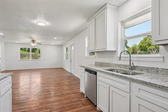 a kitchen with a sink cabinets and window