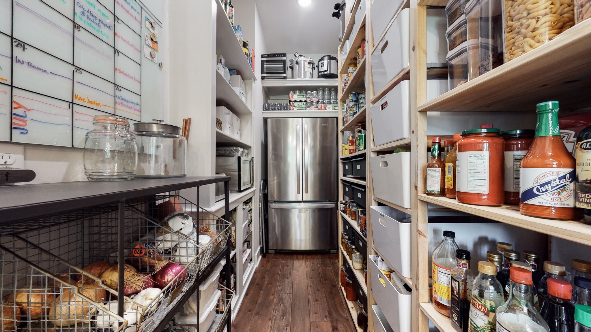 5530 Baker Road Murfreesboro, TN 37129 - Photo 13 of 49 Admit it. You know you love this walk-in pantry. It is massive!! So much storage for your small appliances, dry goods, canning, etc. The "back up" refrigerator/freezer stays with the home as does all the shelving and drawers.
