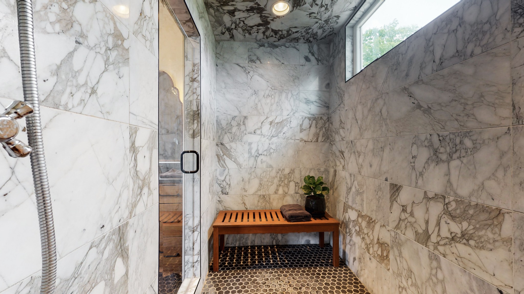 5530 Baker Road Murfreesboro, TN 37129 - Photo 21 of 49 This oversized shower is encased in marble, accented w/ a transom window for natural light, & topped off w/ a Rainfall shower head. The glass door allows the beauty of the stone to be seen, but the placement of the shower head allows for privacy, too