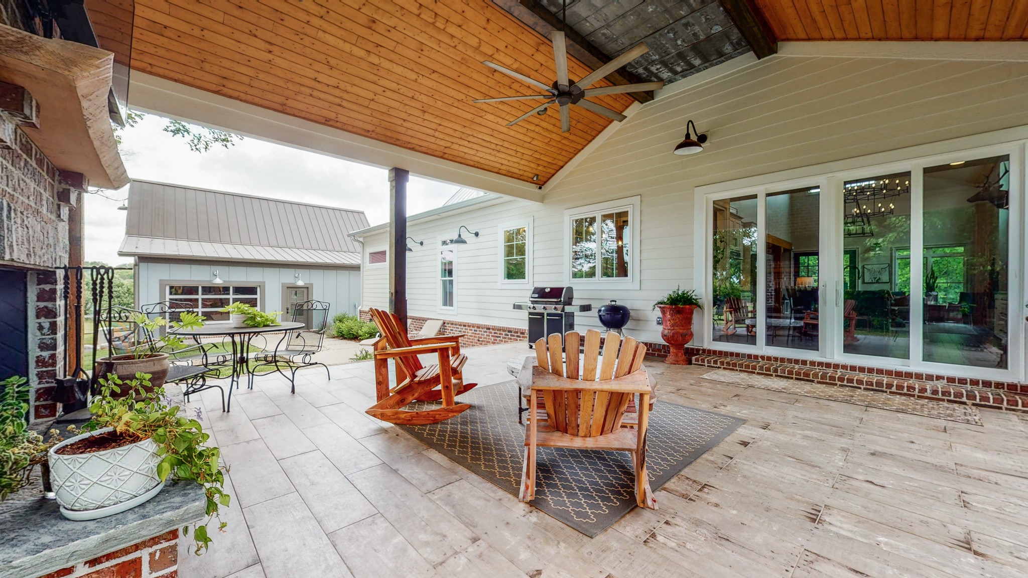5530 Baker Road Murfreesboro, TN 37129 - Photo 30 of 49 Sitting off the kitchen is this glorious covered patio with tiled flooring. A large ceiling fan to keep the breeze moving through, and plenty of space to set up for large or small gatherings, this spot might be your favorite one.