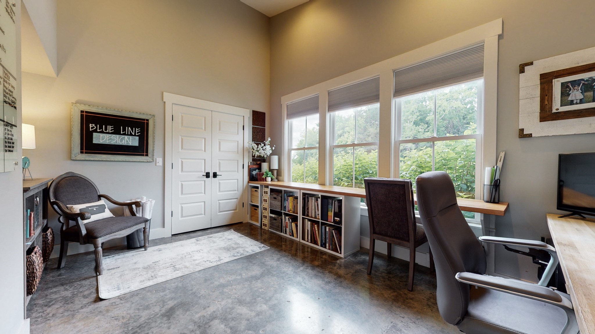 5530 Baker Road Murfreesboro, TN 37129 - Photo 38 of 49 This area faces the driveway and would be considered the bedroom with a large closet. It is currently used as an office with built-in desktops, but could also make a fantastic art room with the high ceilings and natural light.