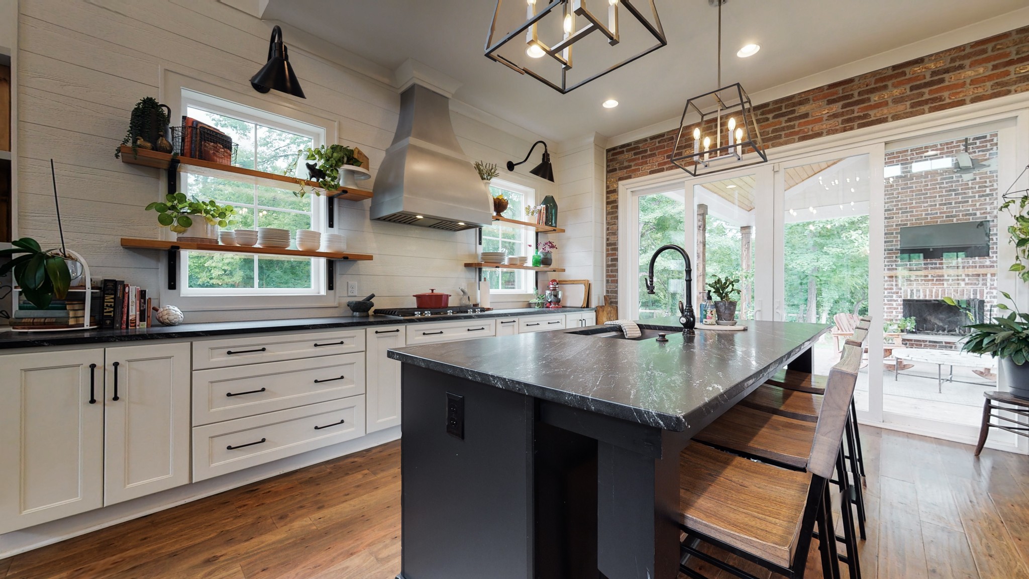 5530 Baker Road Murfreesboro, TN 37129 - Photo 9 of 49 This kitchen has plenty of room for multiple chefs & helpers. The designated "tasters" can sit at the bar and enjoy the show. Shiplap accents the wall, and large sliding glass doors lead out to the rear covered patio.
