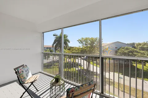 a view of a balcony with chair and wooden floor