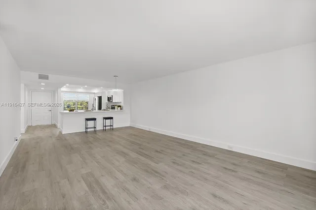 a view of kitchen with furniture and wooden floor