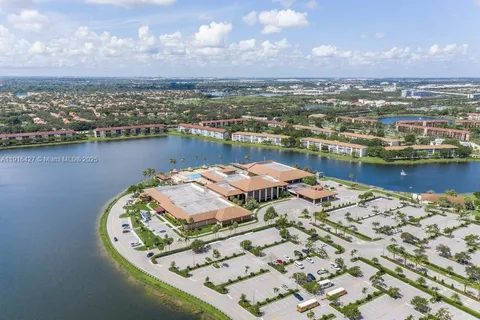 an aerial view of a house with a lake