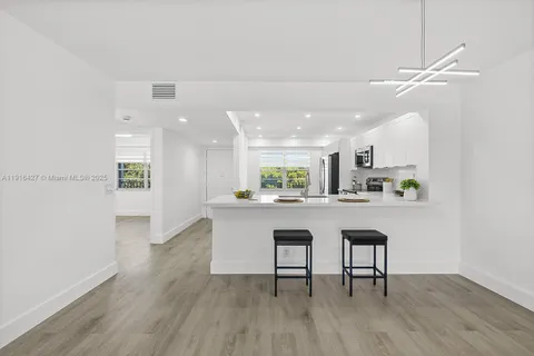 a kitchen with a table and chairs in it