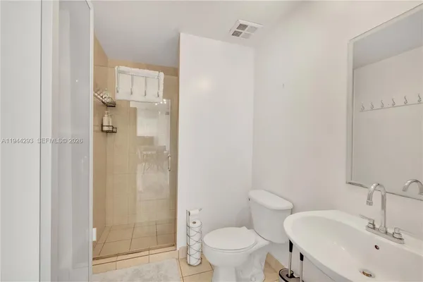 a bathroom with a shower and a toilet