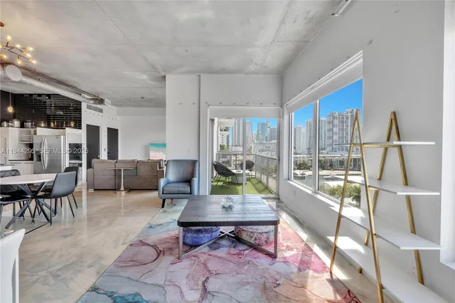 a living room with furniture and a floor to ceiling window