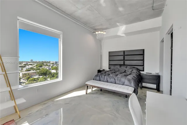 a bedroom with furniture and a window
