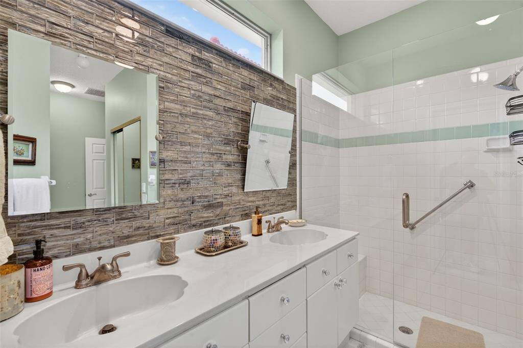 4266 Summertree Road Venice, FL 34293 - Photo 22 of 64 a bathroom with a sink and a mirror
