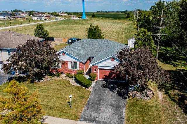 a aerial view of a house with a yard and lake view