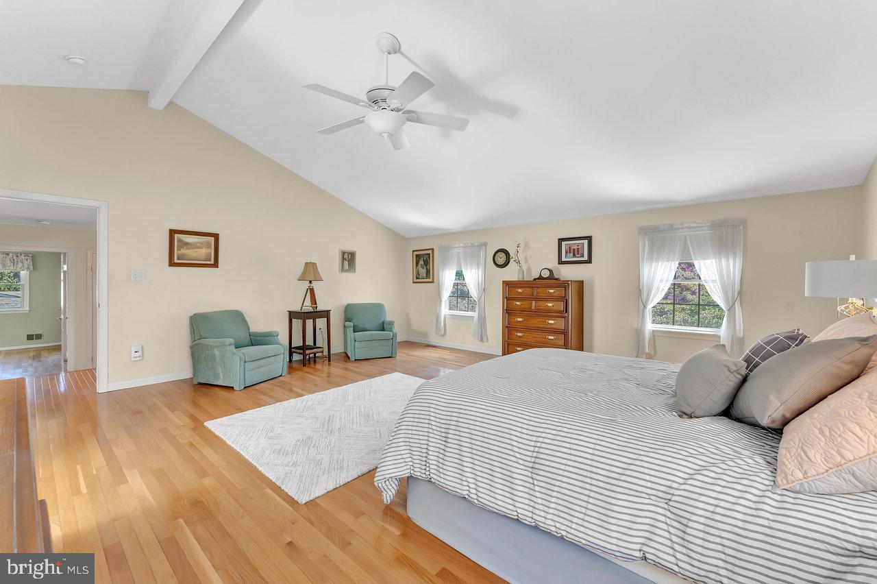 79 Wolfpack Road Hamilton, NJ 08619 - Photo 18 of 30 a spacious bedroom with a bed a dresser and wooden floor