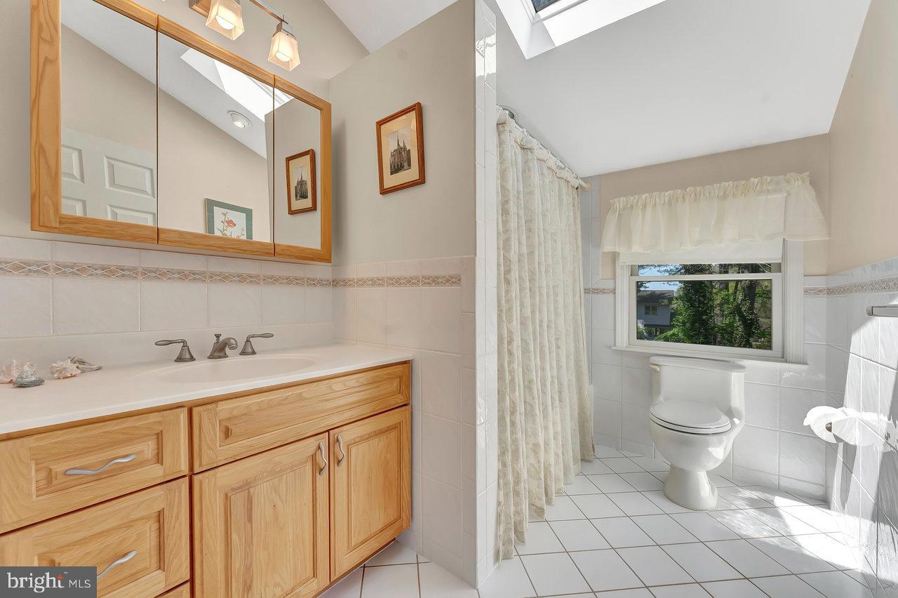 79 Wolfpack Road Hamilton, NJ 08619 - Photo 20 of 30 a bathroom with a sink a toilet and a mirror