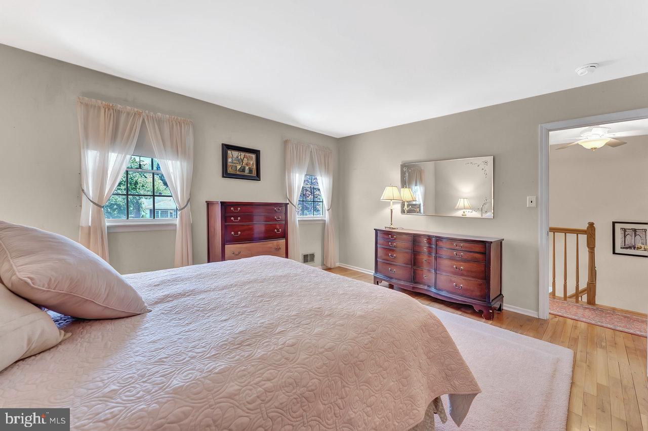 79 Wolfpack Road Hamilton, NJ 08619 - Photo 22 of 30 a bedroom with a bed and a dresser with wooden floor