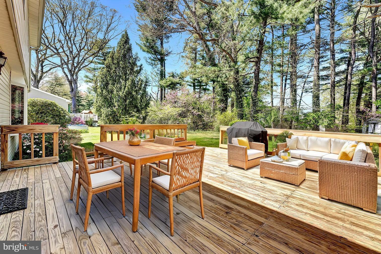 79 Wolfpack Road Hamilton, NJ 08619 - Photo 28 of 30 a view of a patio with dining table and chairs with wooden floor and fence